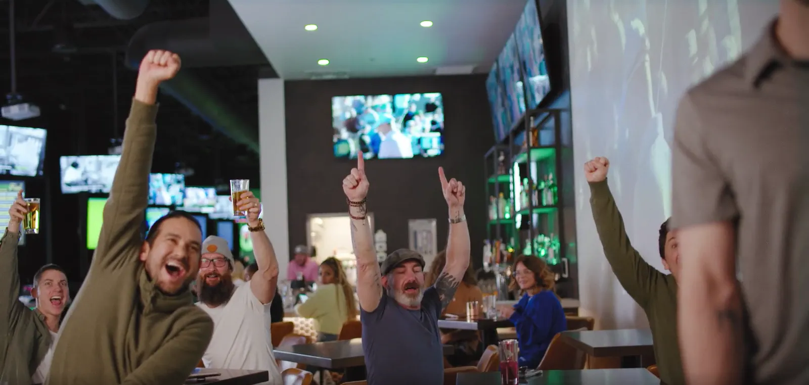 Big-screen TVs over the bar at 1611 Golf Club on game day